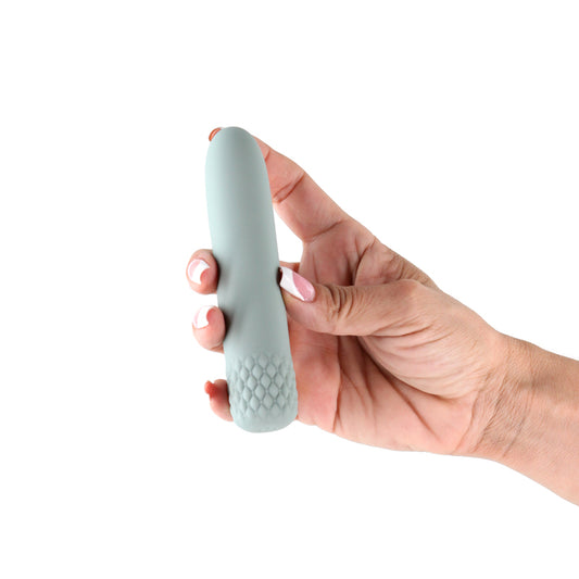 Lust-n-Dreams Mambo. The green bullet held in a hand against a white background.