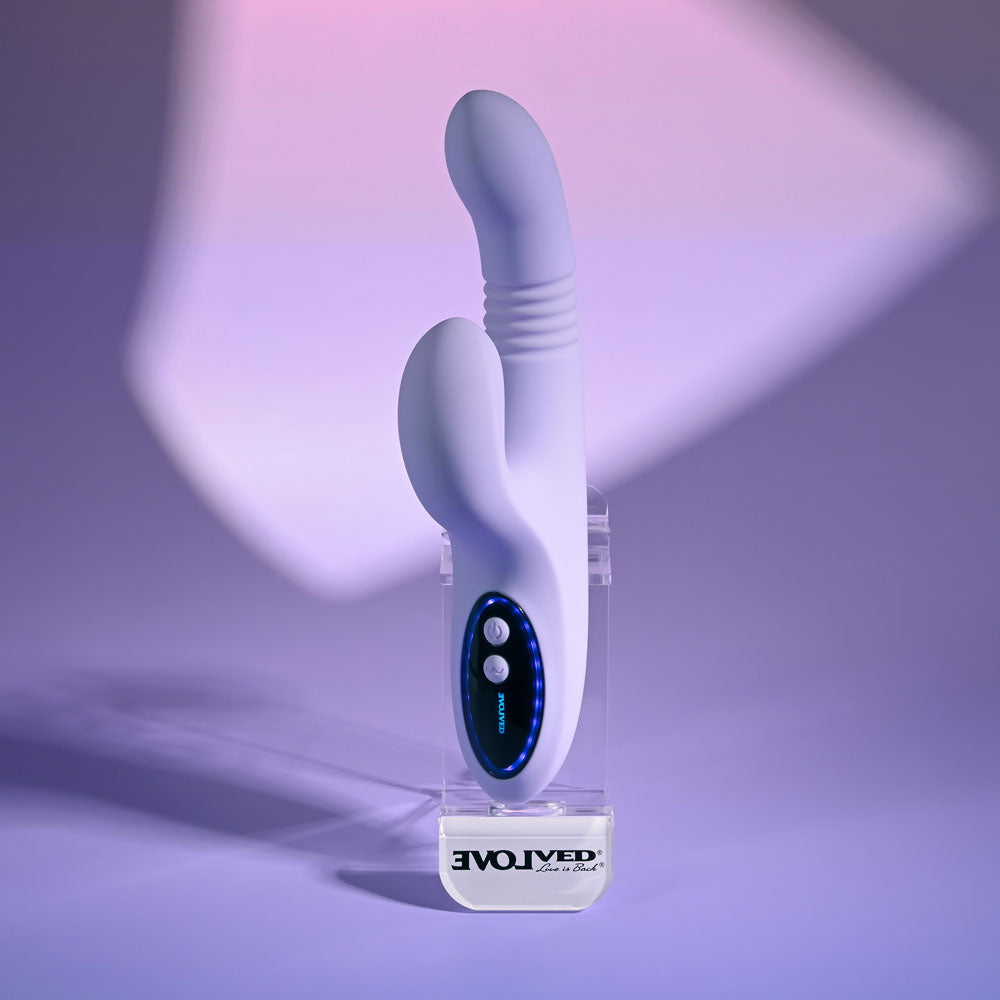 Evolved PEP TALK Purple 23.3 cm Thrusting Vibrator with Tapping. The vibrator on a purple surface.