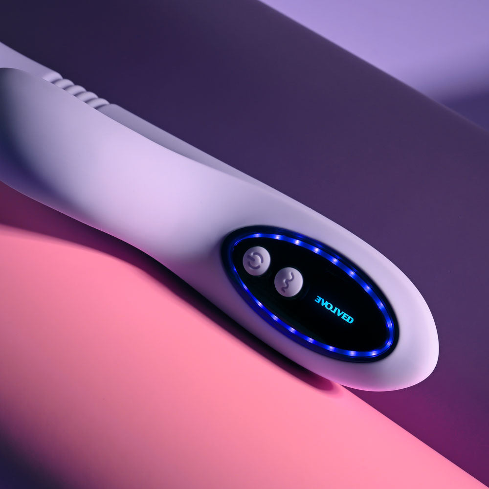 Evolved PEP TALK Purple 23.3 cm Thrusting Vibrator with Tapping. The vibrator on a pink surface.