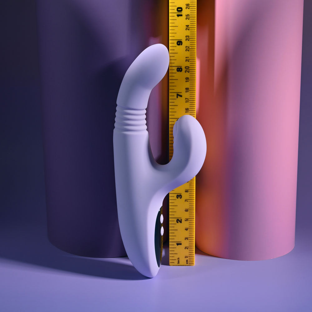 Evolved PEP TALK Purple 23.3 cm Thrusting Vibrator with Tapping. Styled with other products, a fourth view.
