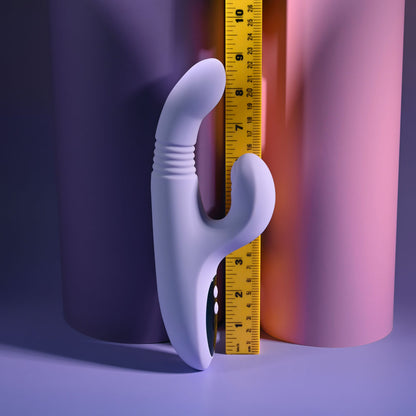 Evolved PEP TALK Purple 23.3 cm Thrusting Vibrator with Tapping. Styled with other products, a fourth view.
