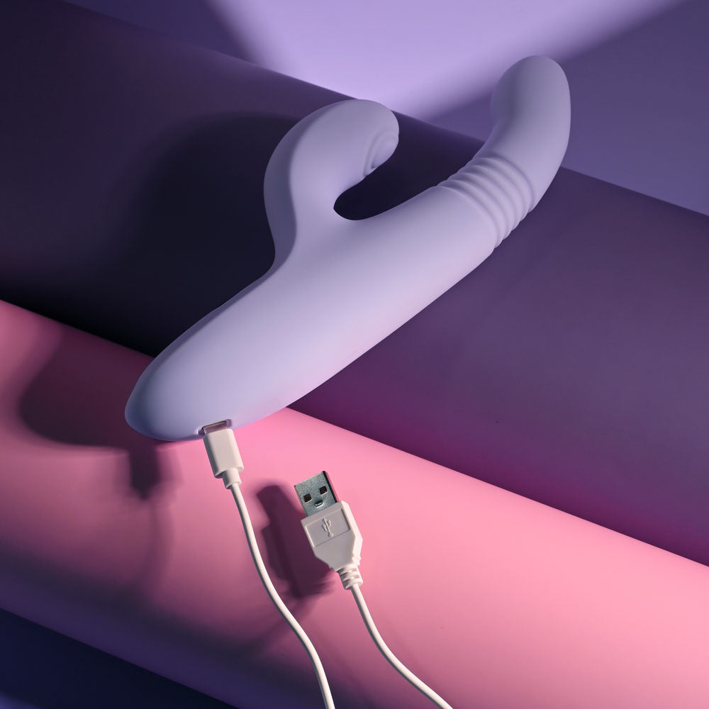 Evolved PEP TALK Purple 23.3 cm Thrusting Vibrator with Tapping. Styled with other products, a fifth view.
