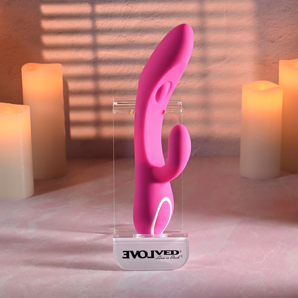 Evolved G-TAPPER Pink USB Rechargeable Rabbit Vibrator. Styled with other products, a third view.