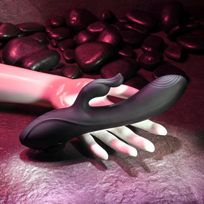 Evolved RABBIT HOLE. The black vibrator on a coloured surface, tighter crop.