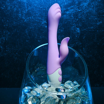 Evolved PLEASING PETAL. The blue vibrator on a coloured surface.