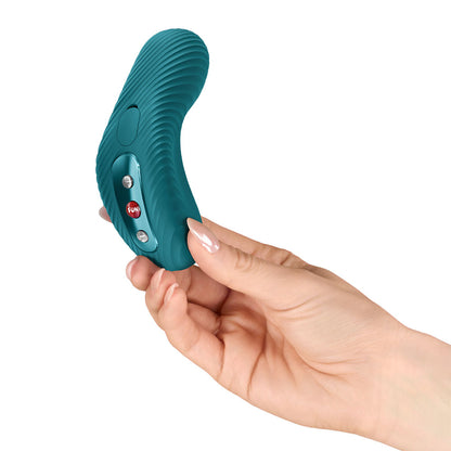 Teal handheld device held in a hand on a white background