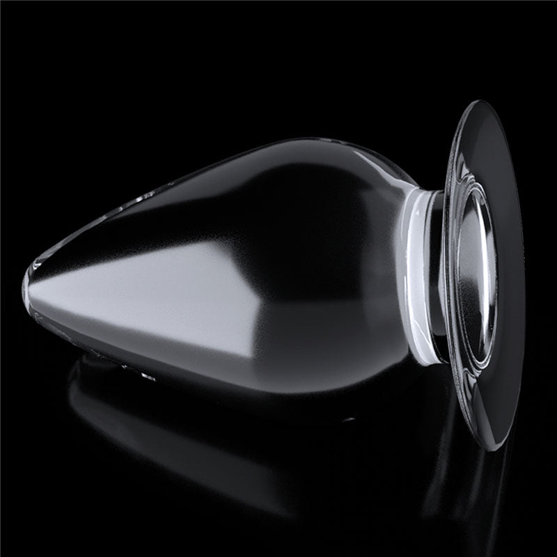 Flawless Clear Anal Plug 4.5''. The butt plug on a coloured surface, tighter crop.