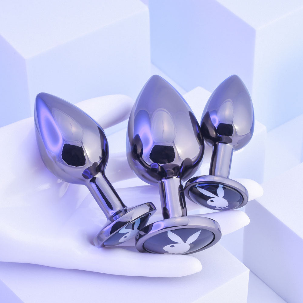 Playboy Pleasure PLEASURE 3 WAYS. The purple product on a wet blue surface, a fourth view.