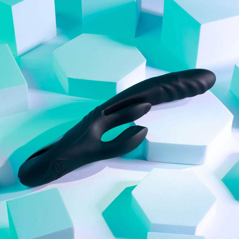 Black glove on a geometric, multicolored surface
