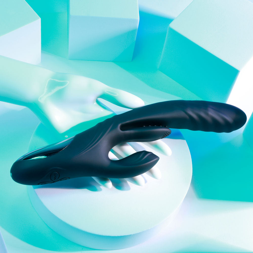 Black plastic tool on a teal and white abstract background