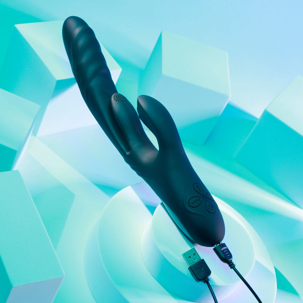 Black electronic device with USB cable on a blue geometric background