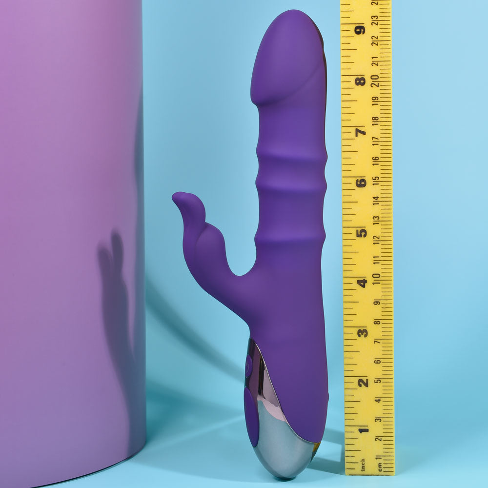 Purple and gray toy with a yellow measuring tape on a blue background