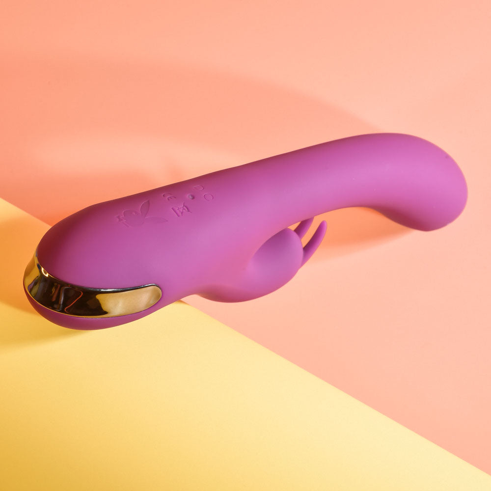 Purple and gold device on a pink and yellow gradient background