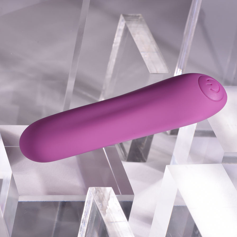 Purple electronic device on a geometric gray background