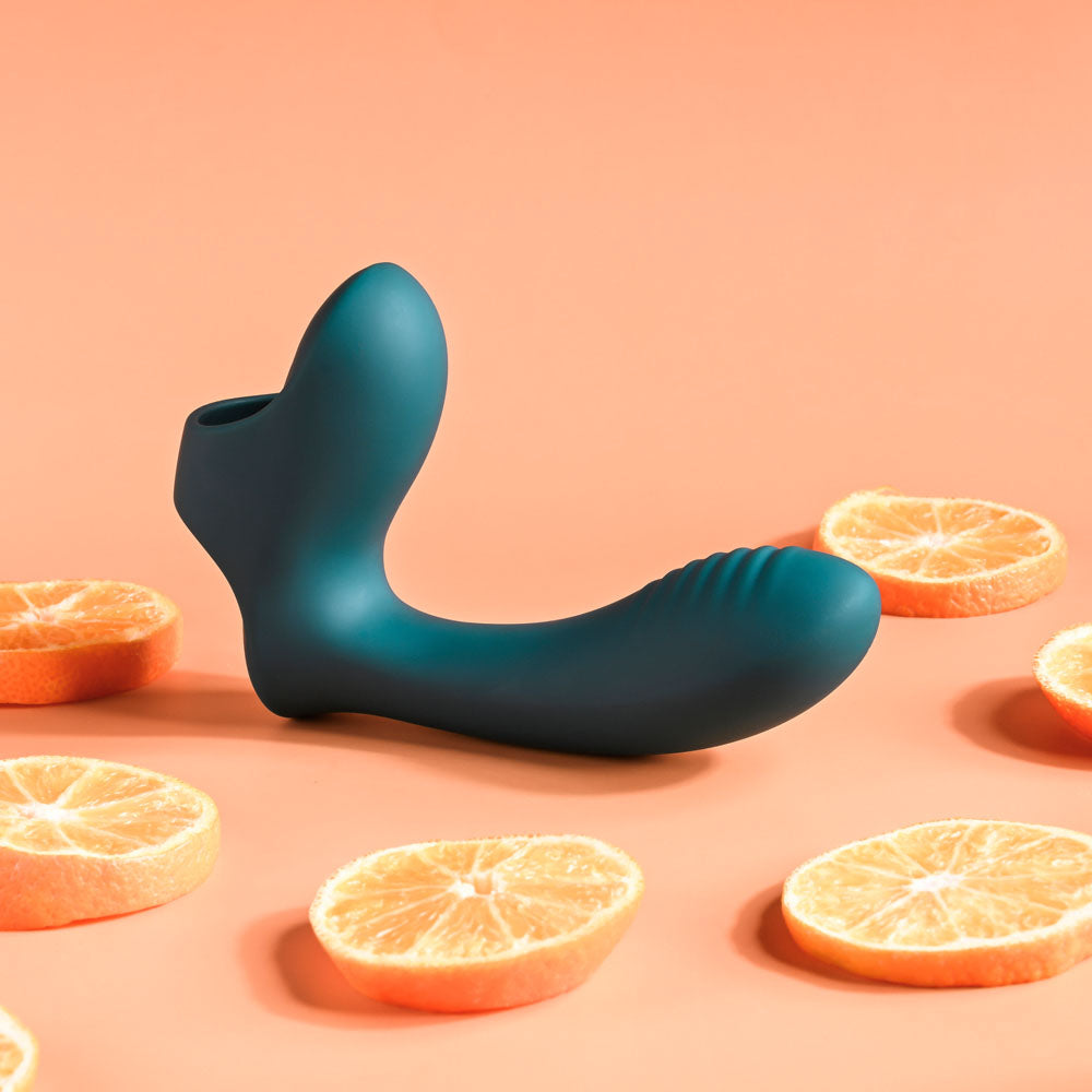 Blue toy with sliced oranges on a peach background