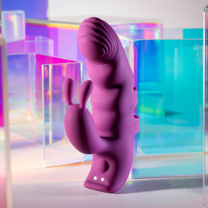 Purple silicone product with abstract design against a colorful geometric background