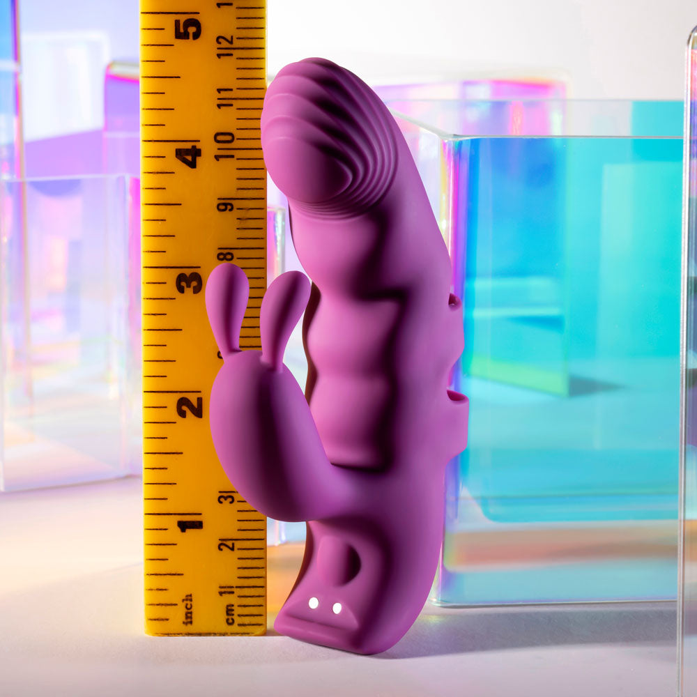 Purple silicone product with a ruler for scale against a colorful background