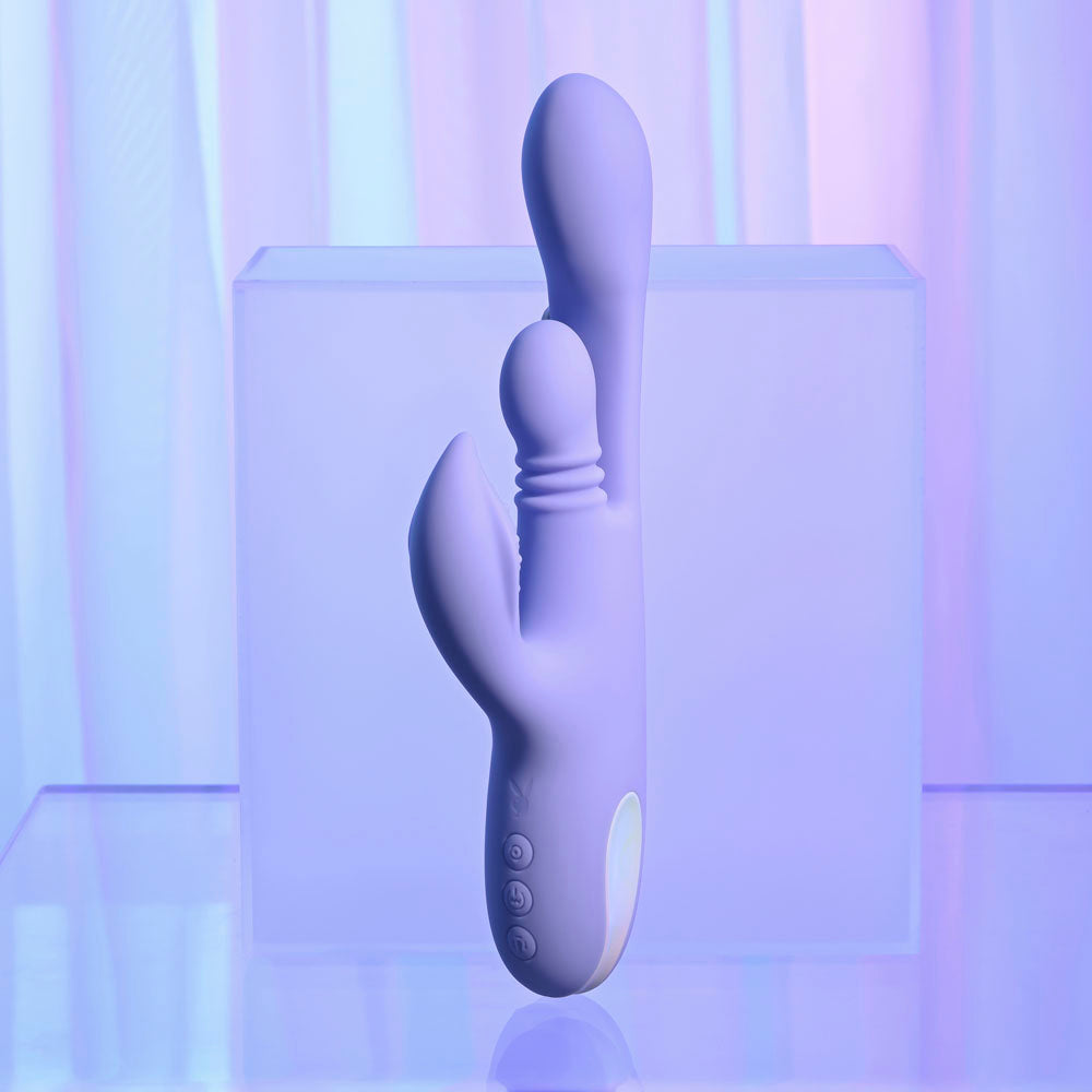 Purple electronic device on a reflective surface with a gradient background