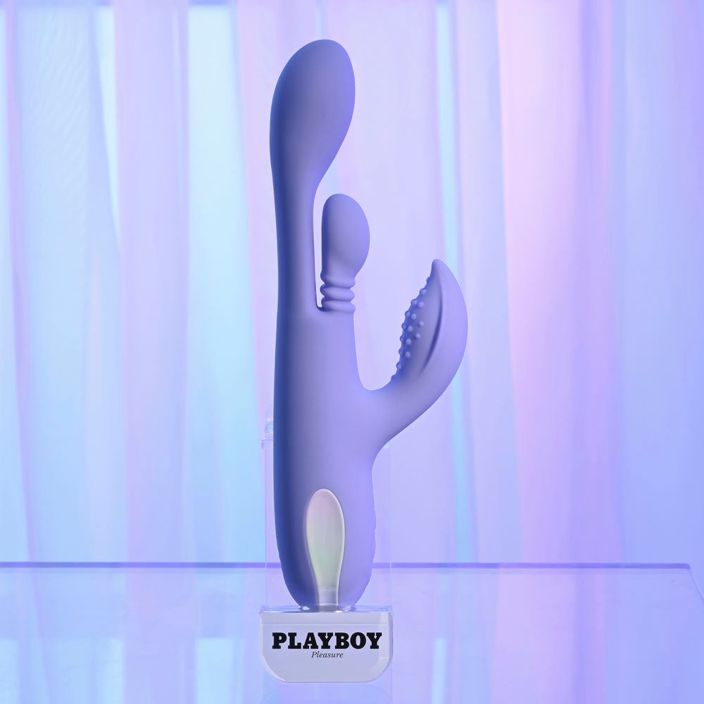 Playboy branded purple and white toy on a gradient background