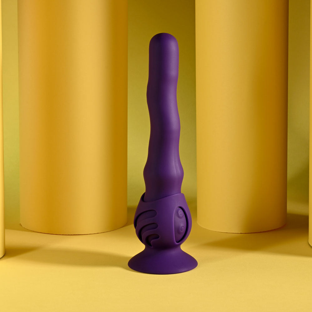 Purple silicone suction cup with textured design on a yellow background