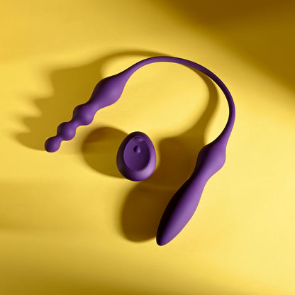 Purple neck massager on a yellow background