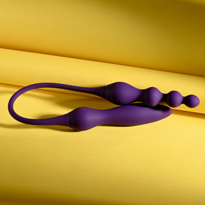 Purple silicone wand on a yellow background