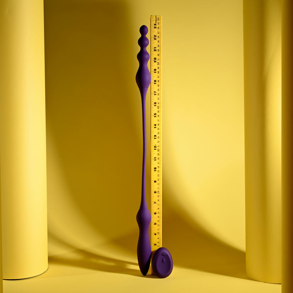 Purple measuring tool with a ruler on a yellow background