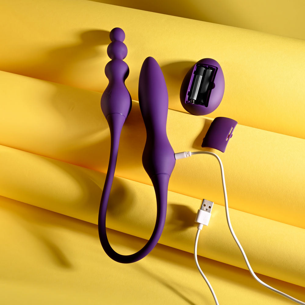 Purple electronic device with USB cable on a yellow background