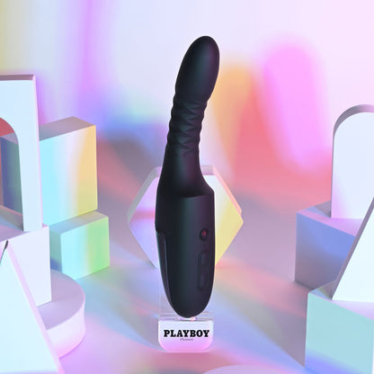 Black electronic device on a stand with 'Playboy' branding against a colorful geometric background