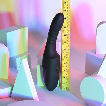 Black shoe tree with a measuring tape on colorful geometric shapes