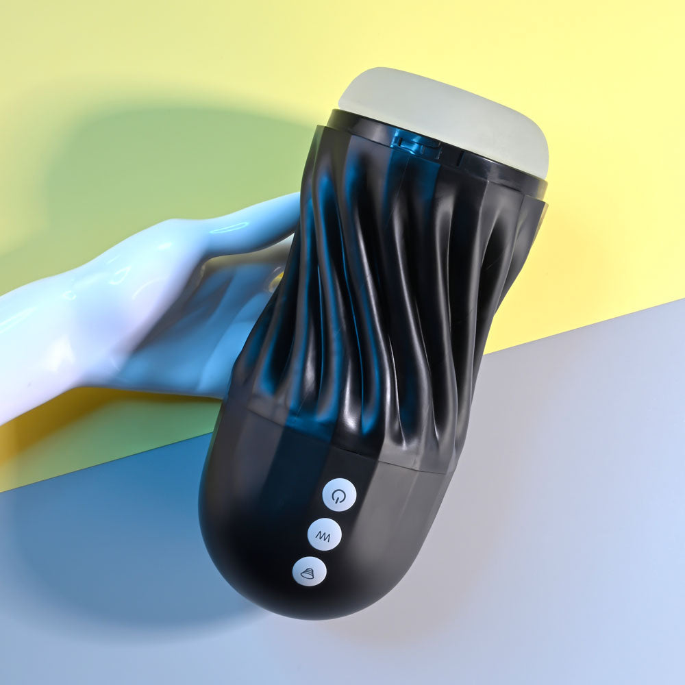 Black handheld device with buttons on a colorful background