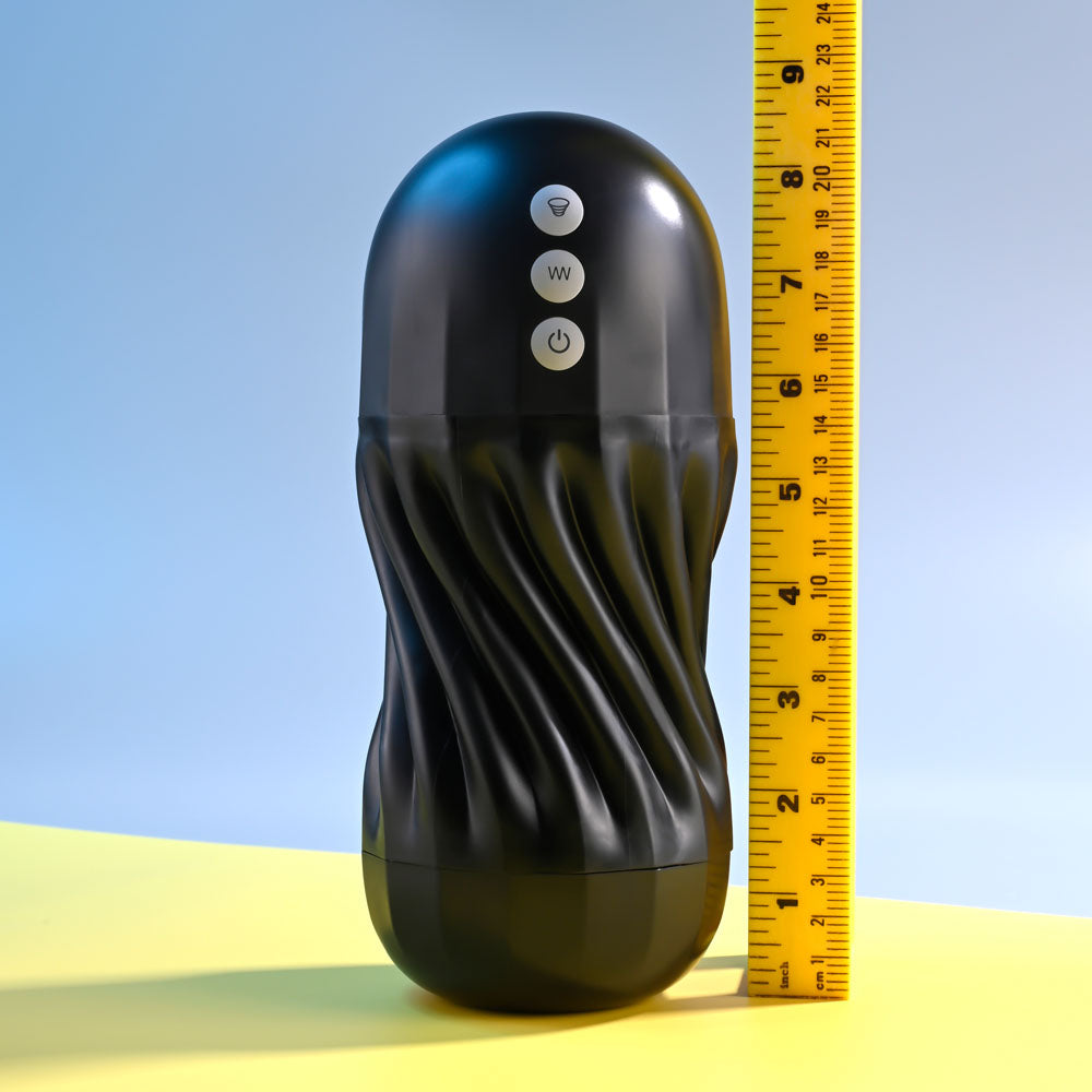 Black textured cylindrical device with control buttons next to a yellow measuring tape on a blue and yellow gradient background.