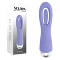 Purple silicone product with silver base next to its packaging on a white background