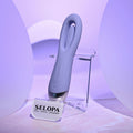 Purple electronic device on a stand with 'SELOPA' branding in a purple-lit setting