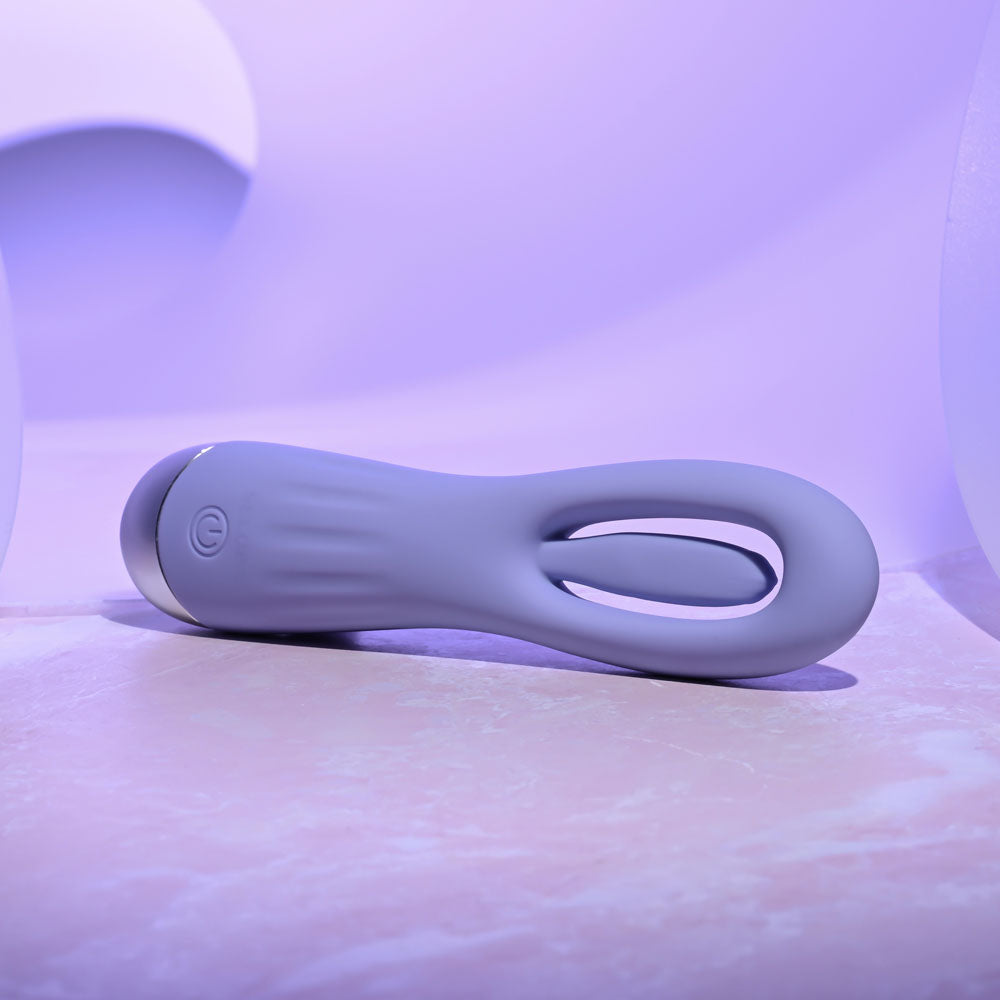 Purple electronic device on a white surface with a soft purple background