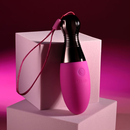 Selopa COMPANION Pink 11.9 cm USB Rechargeable Vibrating Egg. The product on a pink surface, tighter crop.