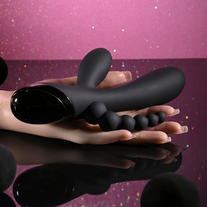Black flexible tool held in hands against a pink and purple gradient background
