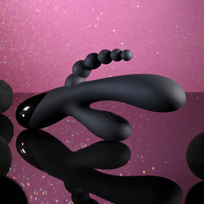 Black spiral object on a pink glittery background