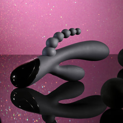 Black and gray object on a pink glittery background