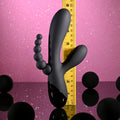 Black massage tool with measurement scale on a pink and purple gradient background