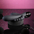 Gray foot-shaped device with a USB connection on a reflective surface against a purple gradient background.