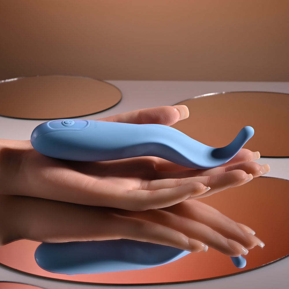 Blue electronic device held in hands with a neutral background