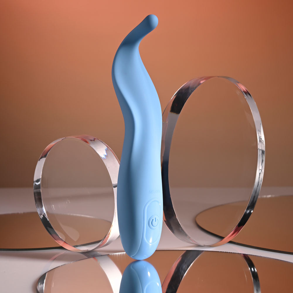 Blue hair tie with clear plastic loops on a reflective surface