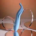Blue hair clip with clear circular components on a reflective surface
