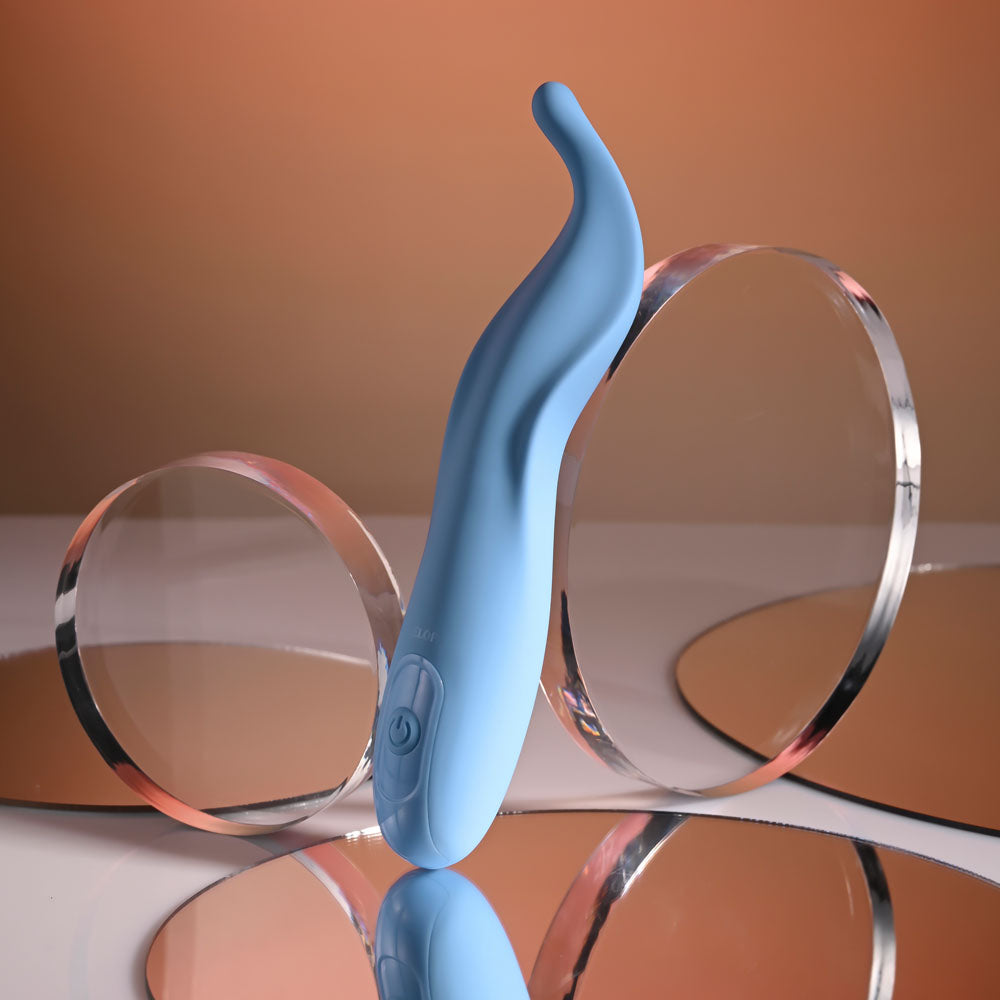 Blue hair clip with clear circular components on a reflective surface