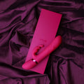Pink 'VIVE' product on a matching pink card against a purple fabric background