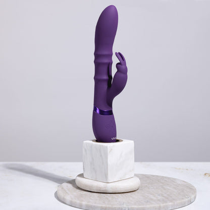 Purple toy on a marble stand against a light gray background