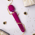 Purple toy with 'Vive' branding on a white surface with decorative elements