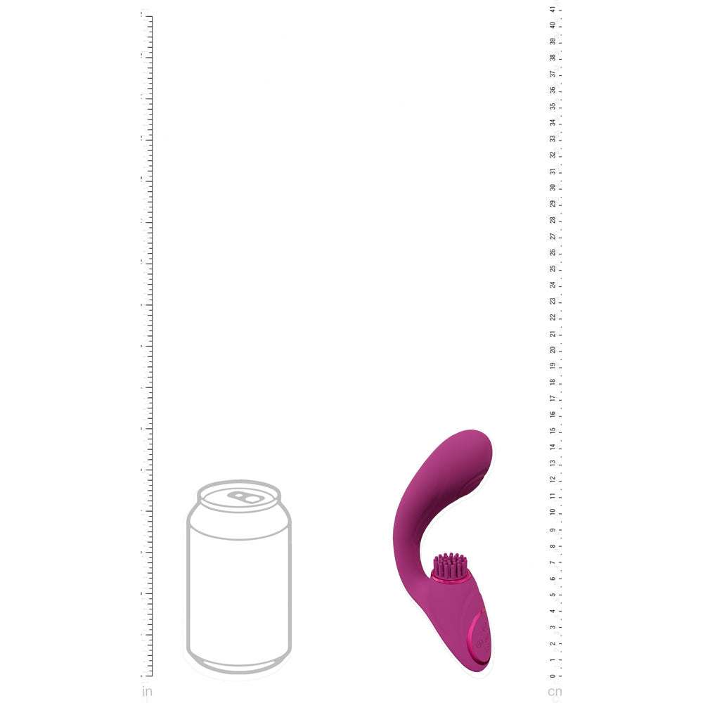 Purple toy with a can for scale on a white background