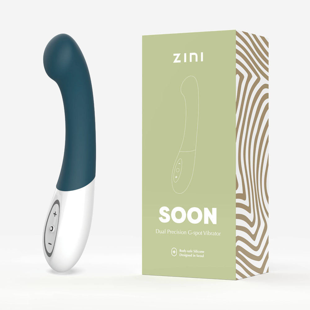 Green and white dual-precision gripper with ZINI packaging on a light gray background